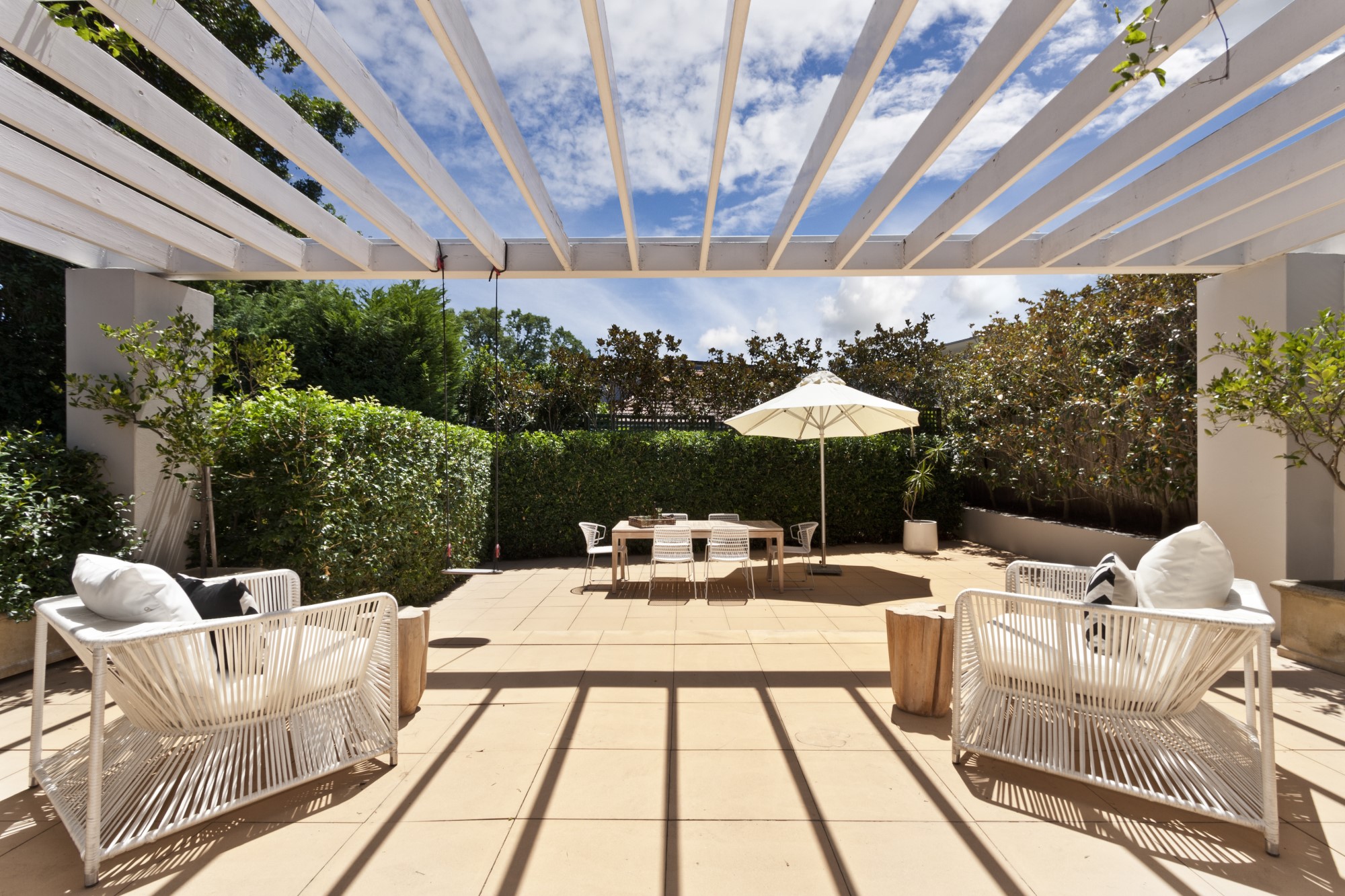 Natural stone patio area with comfortable seating looking out to the garden